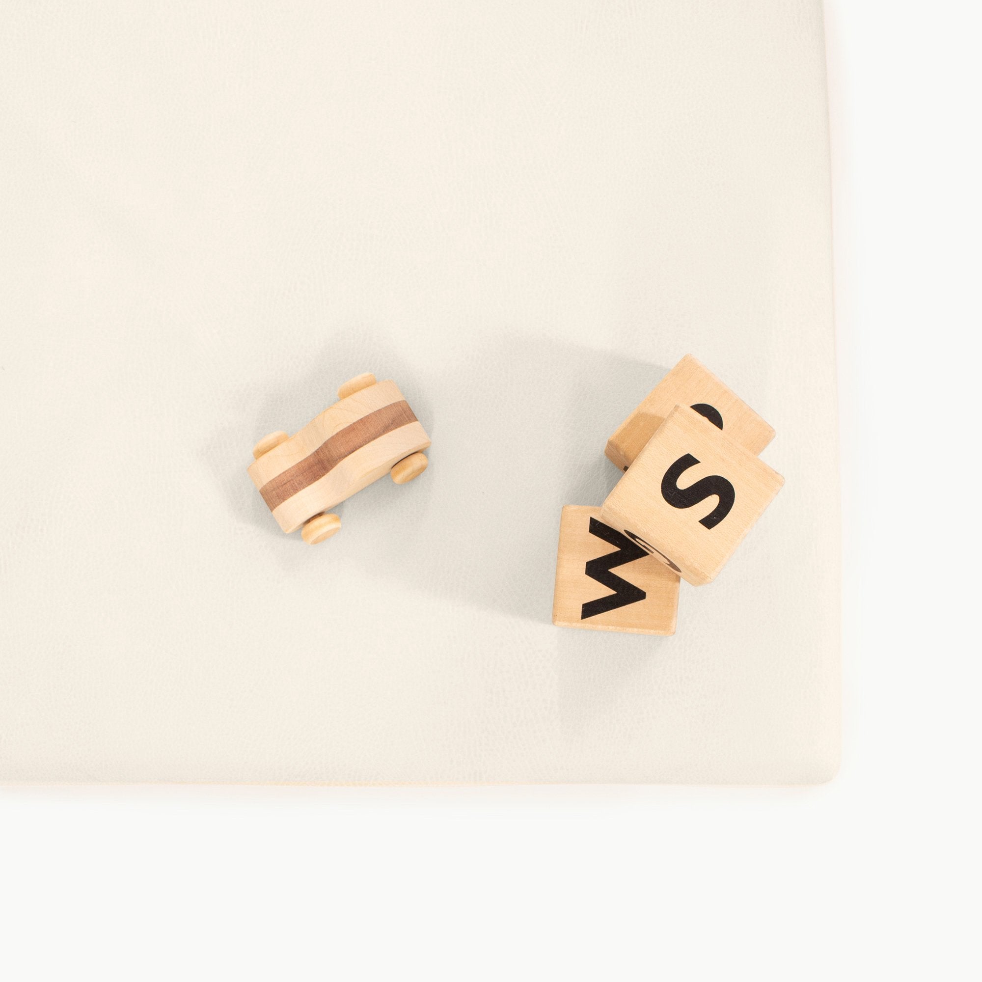 Ivory / Square@Detail of toys on Ivory Padded Mini Square