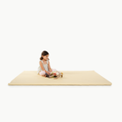 Mellow@little girl sitting on padded mat