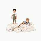 Menagerie@Little kids laying on Menagerie products