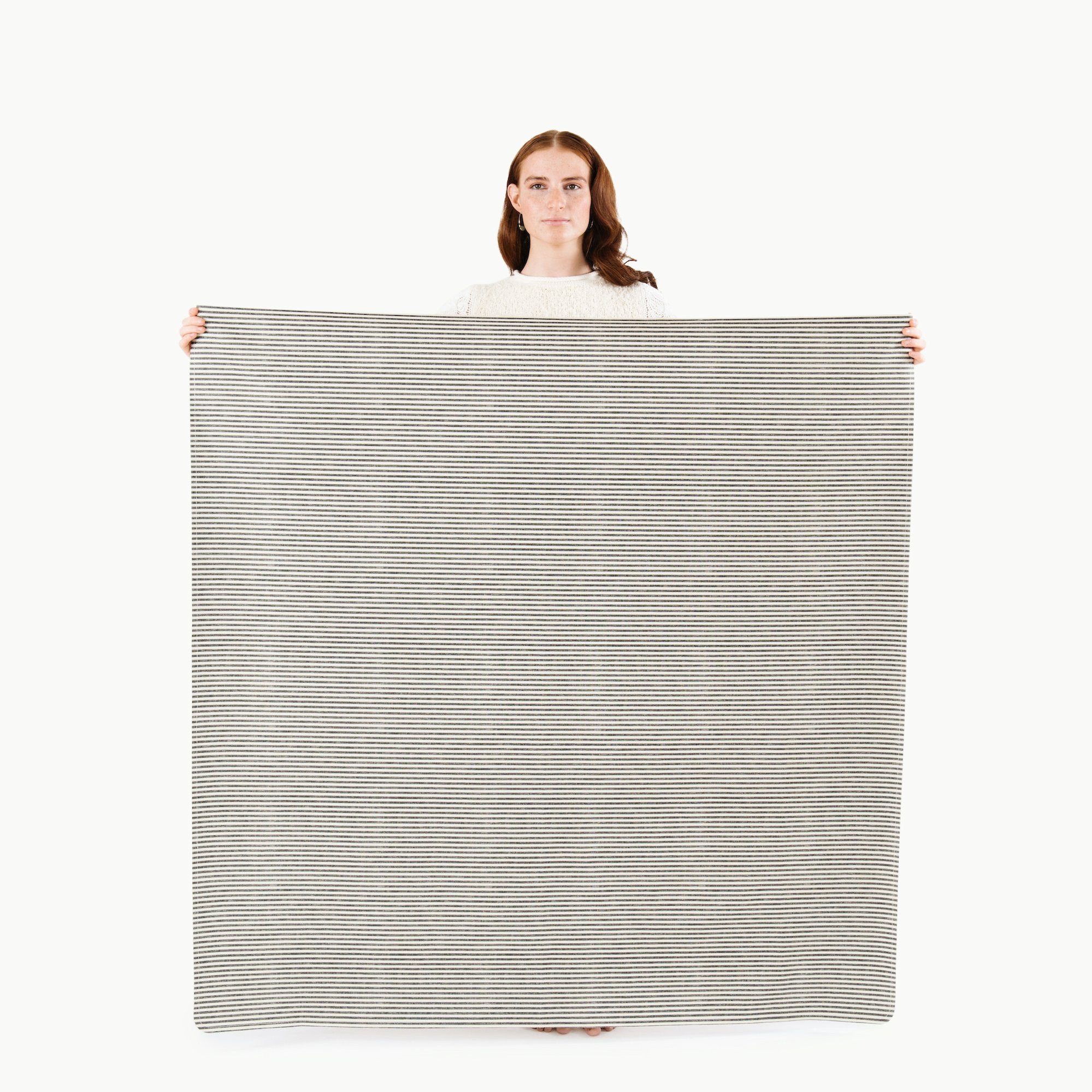Stone Stripe@woman holding the stone stripe midi mat