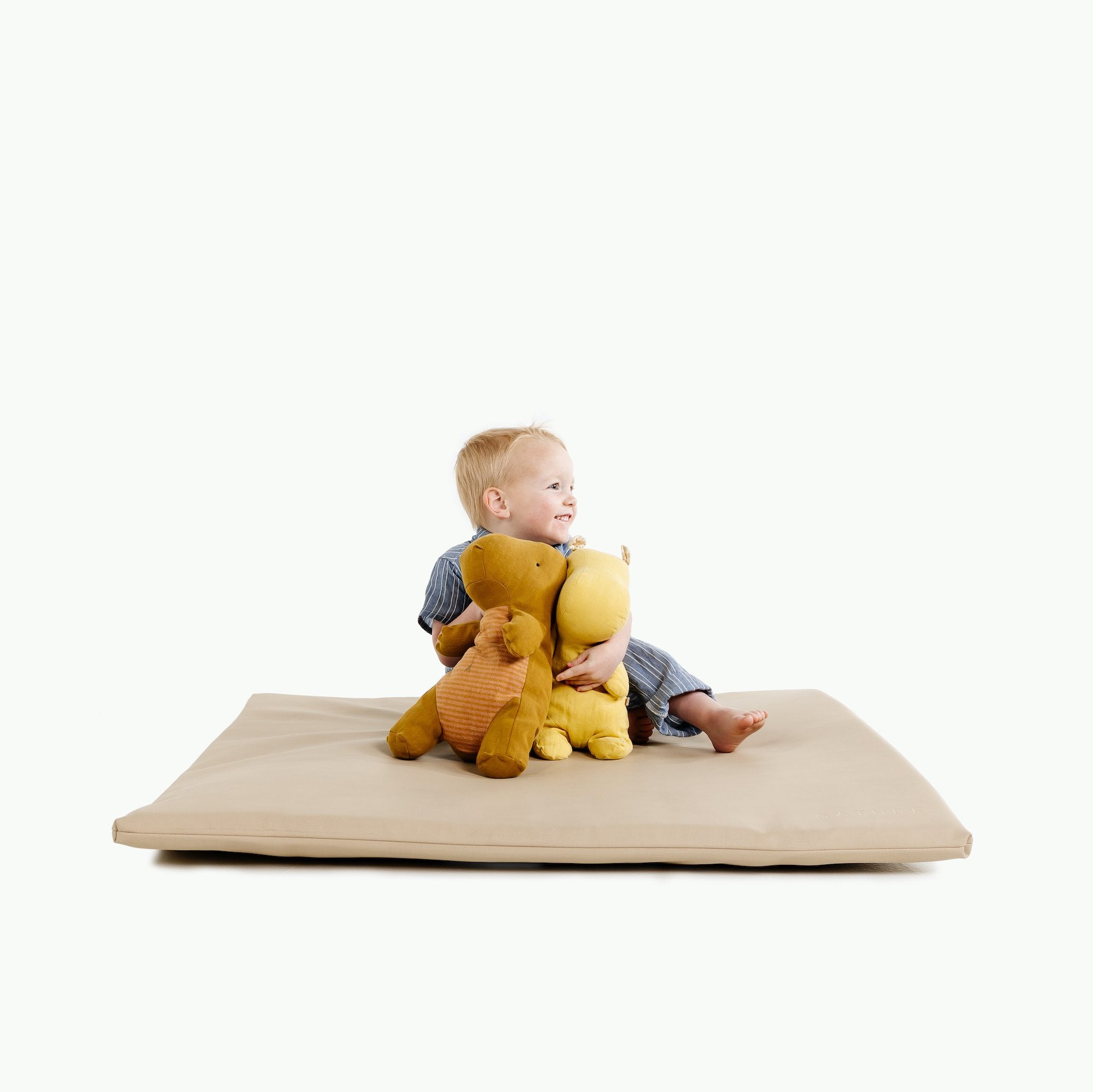 Millet / Square@Boy sitting on Millet Padded Mini Square