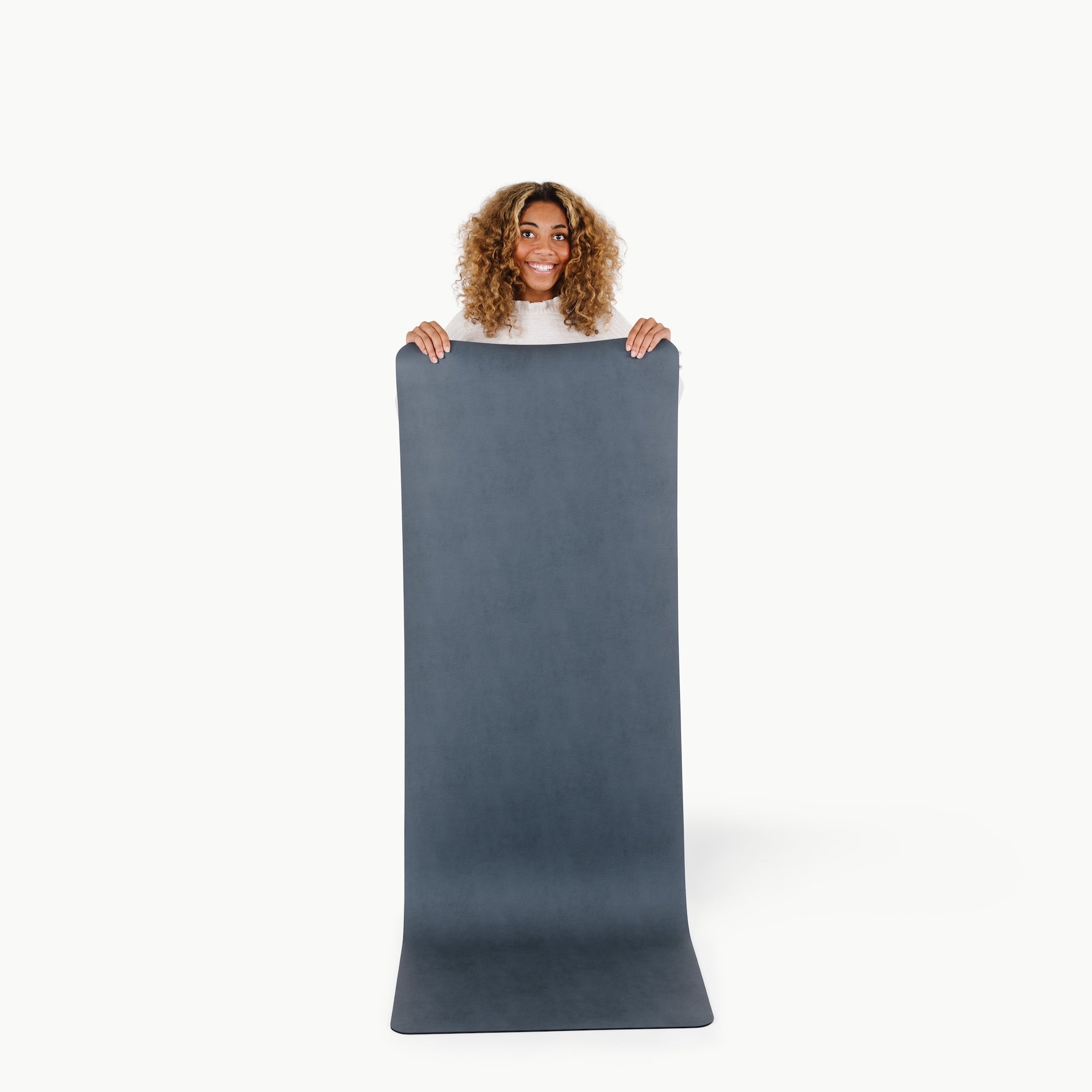 Nightfall (on sale)@woman holding up the large home mat