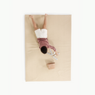 Créme (on sale)@overhead of little boy on padded mat