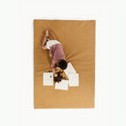 Tassel (on sale)@overhead of little boy on mat