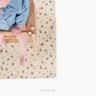 Peter Rabbit™ (on sale)@overhead of little girl in a high chair on a mat