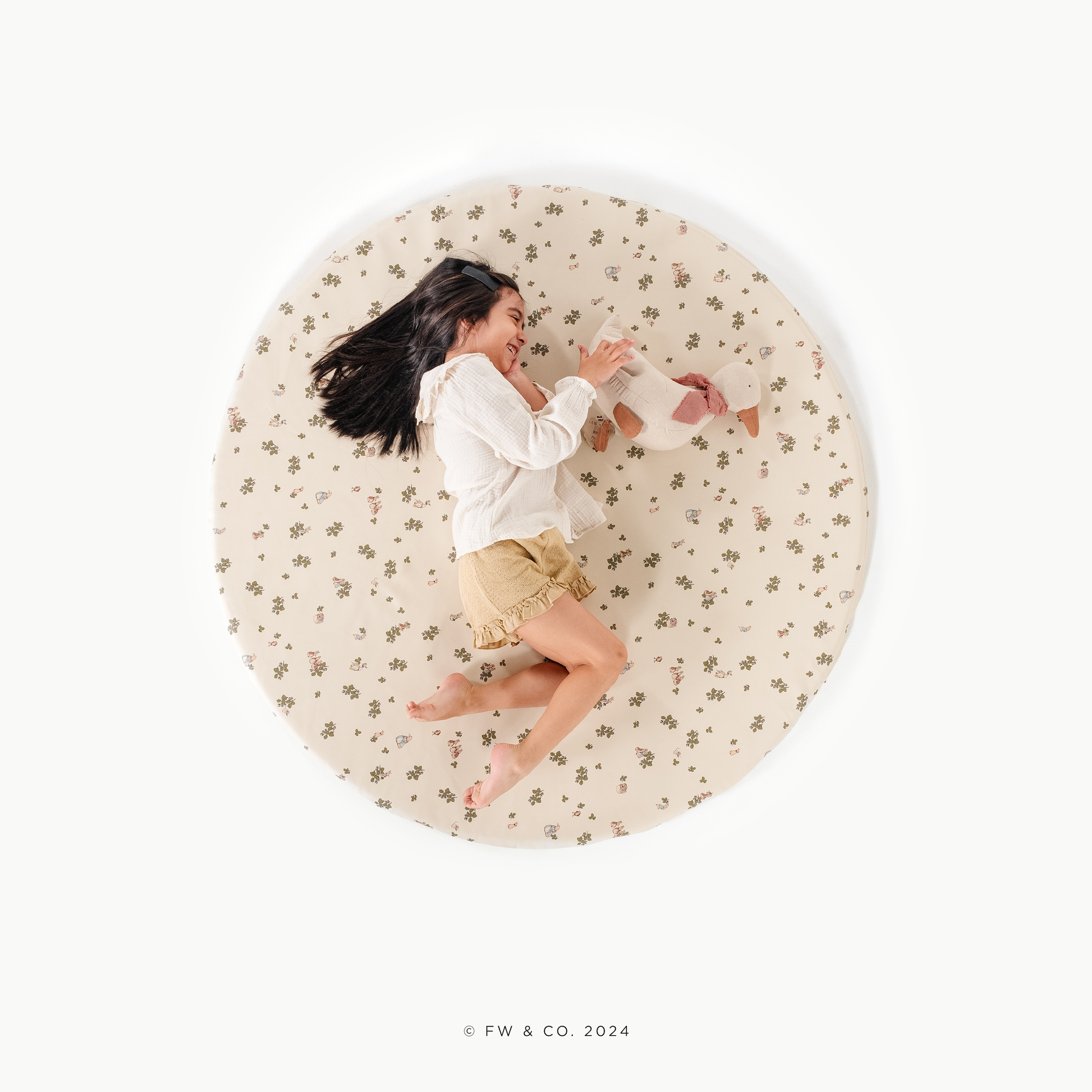 Peter Rabbit™ (on sale)@overhead of a little girl on a padded midi circle