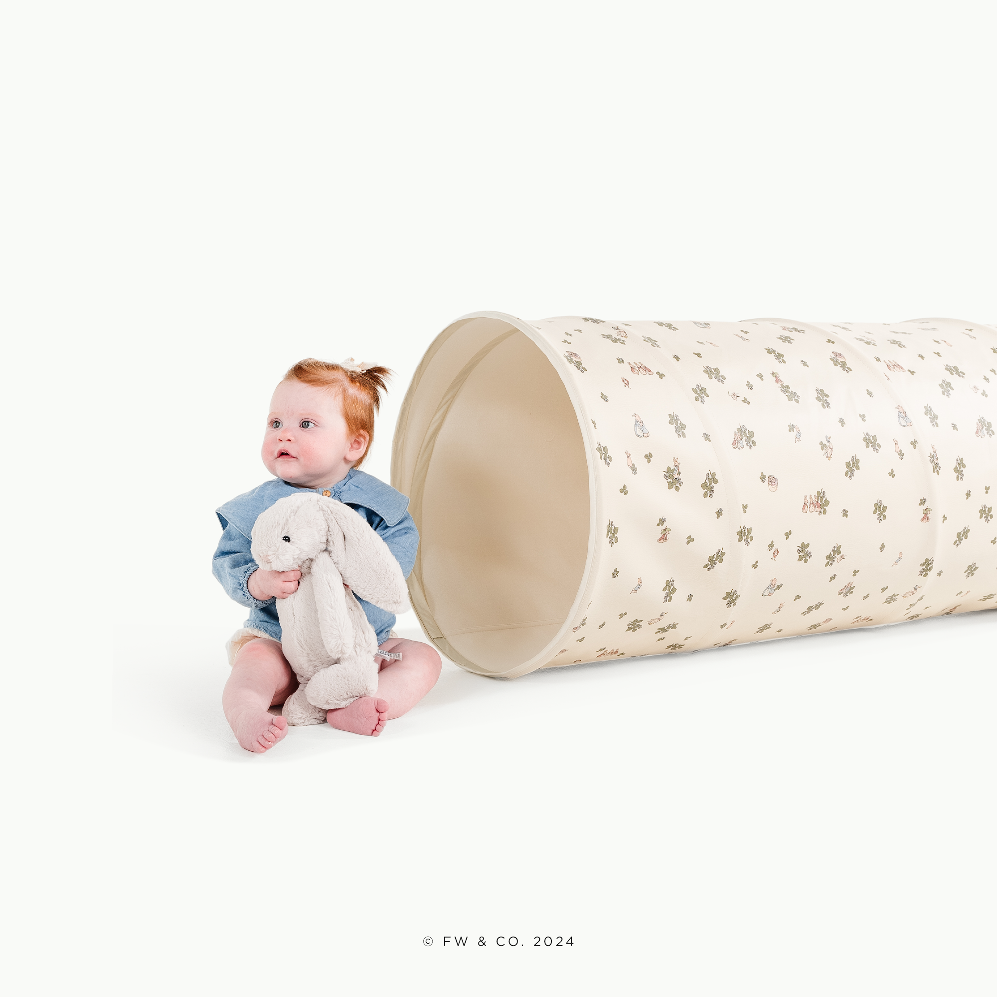 Peter Rabbit™@little girl playing next to a tunnel