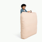 Pomelo (on sale) / Square@Kid holding the Pomelo Square Floor Cushion