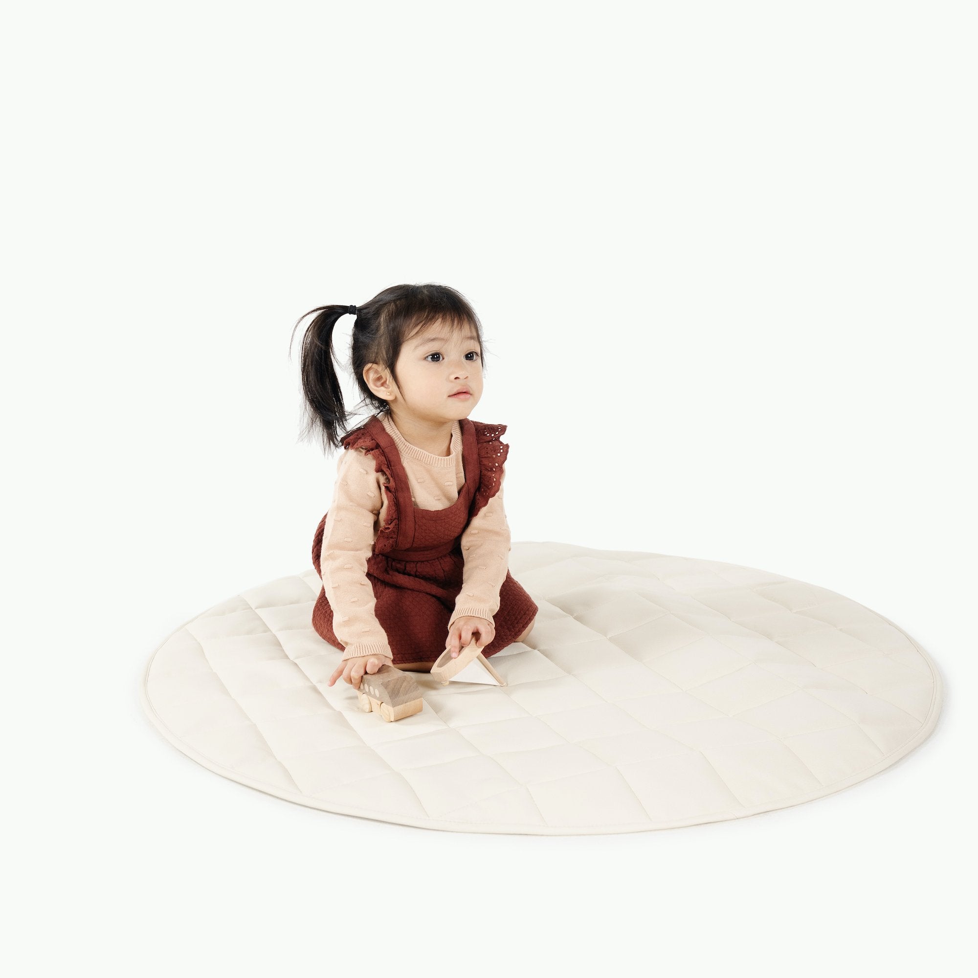 Ivory / Circle@Kid sitting on the Ivory Mini Circle Quilted Mat
