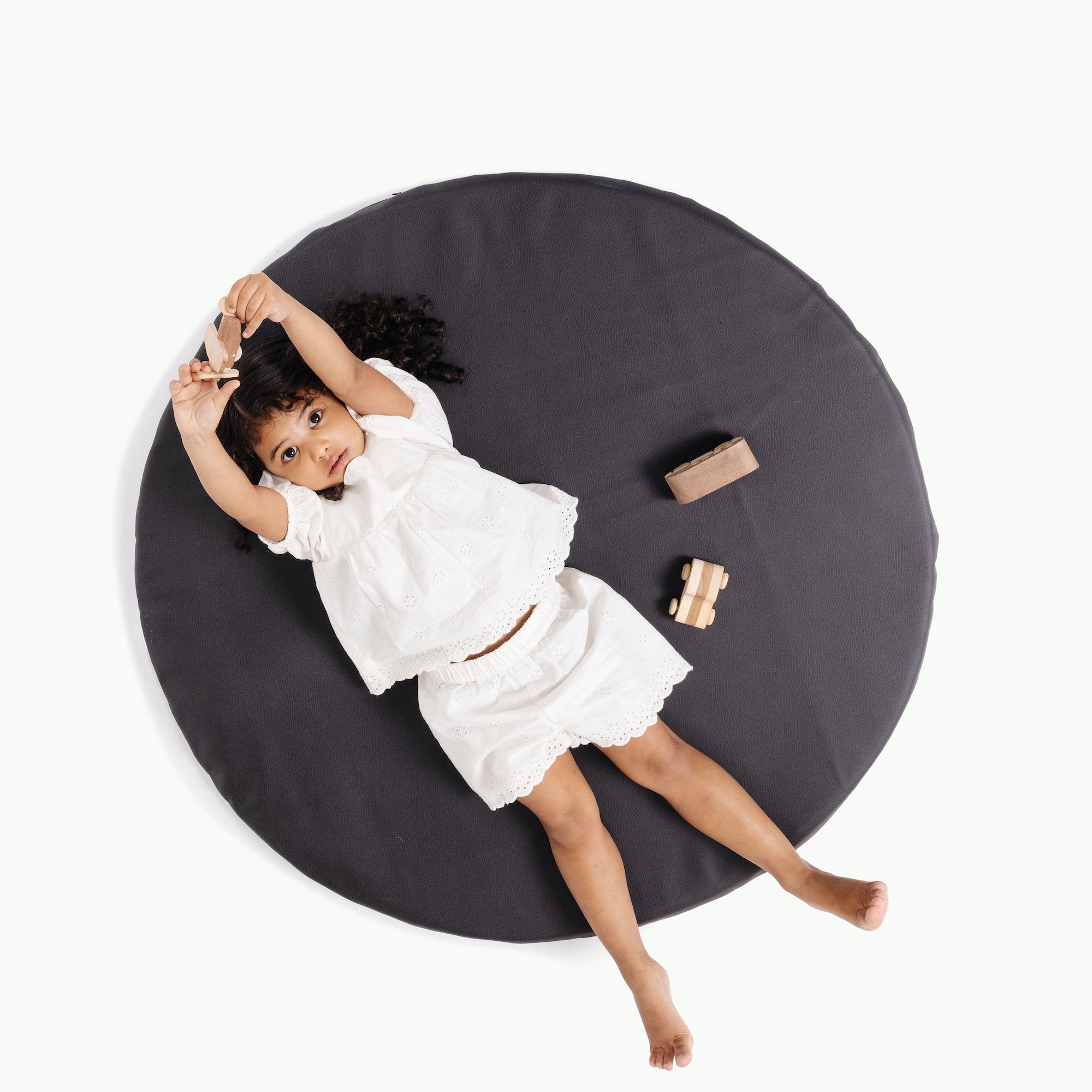 Raven (on sale) / Circle@Ovehead of kid laying on Raven Padded Mini Circle