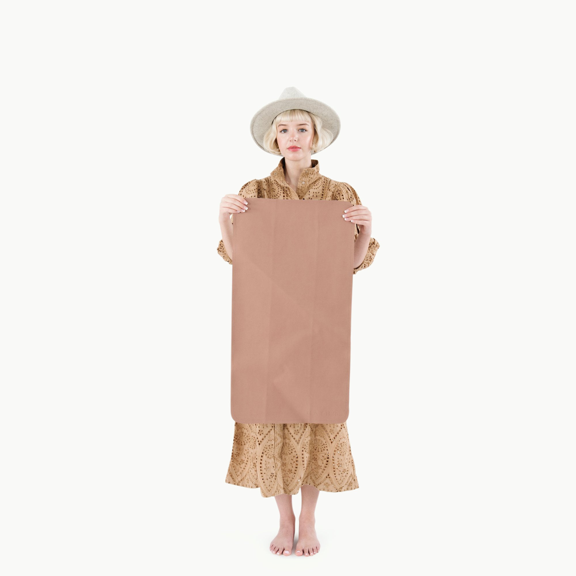 Sienna (on sale)@woman holding the sienna micro+ mat