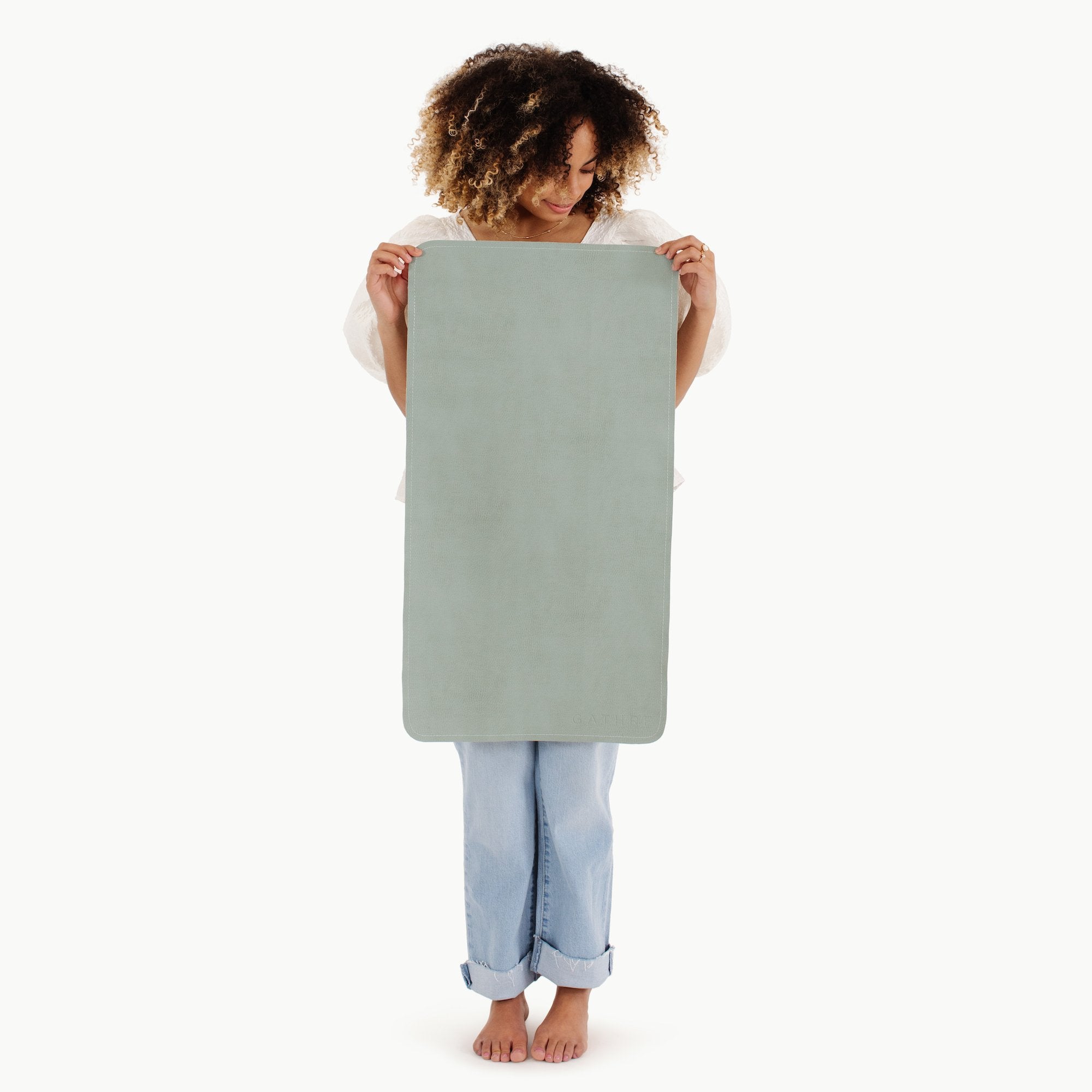 Isle (on sale)@woman holding the isle micro+ mat