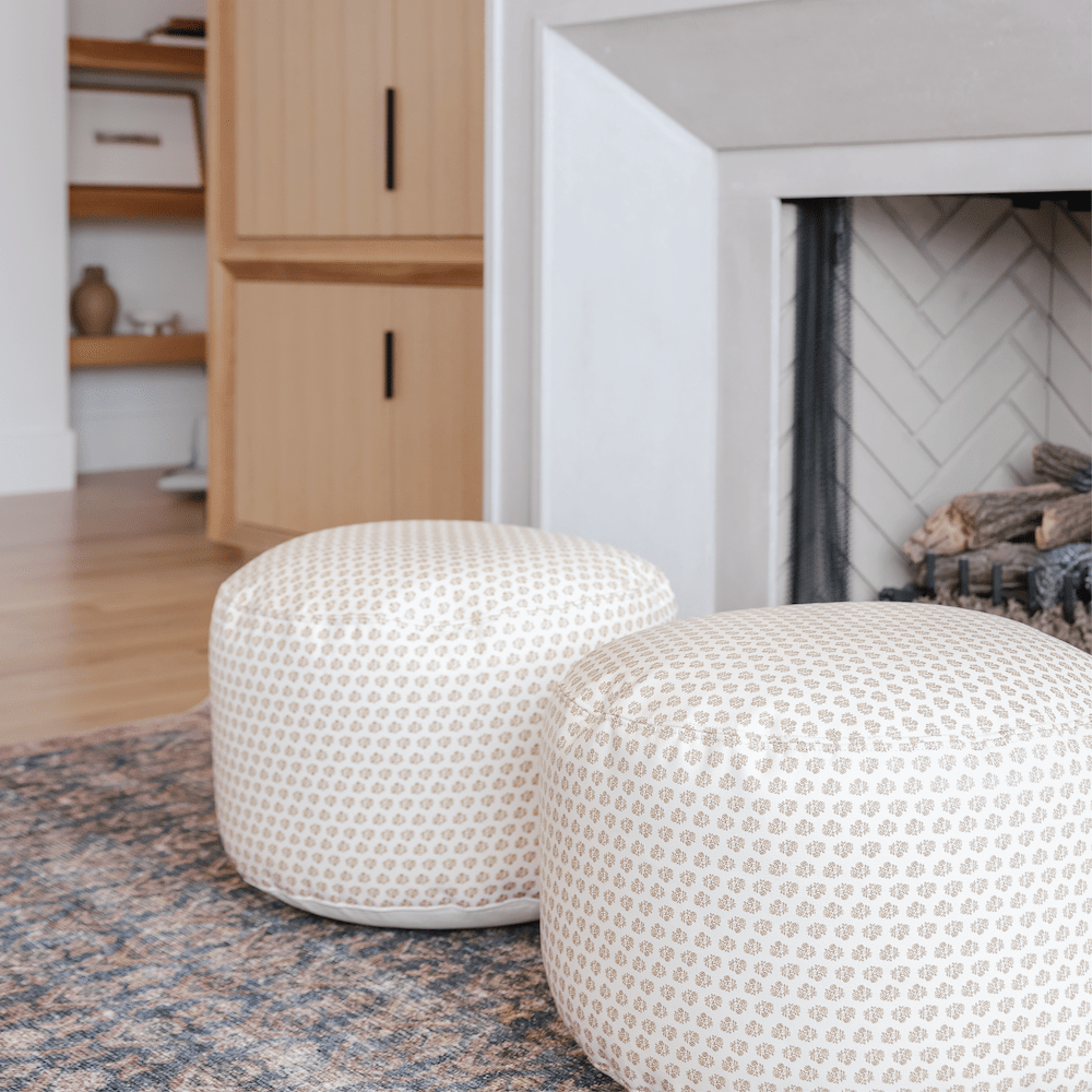 Bloom (on sale)@Bloom Circle Poufs in front of a fireplace