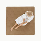Tannin (on sale) / Square@Overhead of woman sitting on the Tannin Square Midi Mat