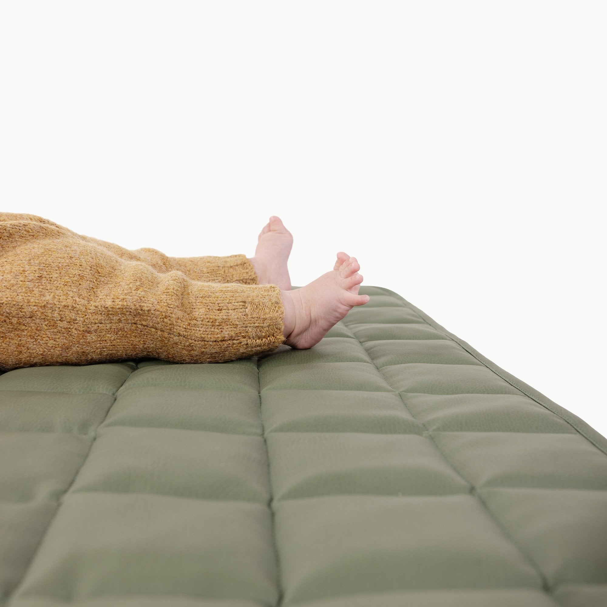 Thyme / Square@Close up of baby laying on the Thyme Square Quilted Mat