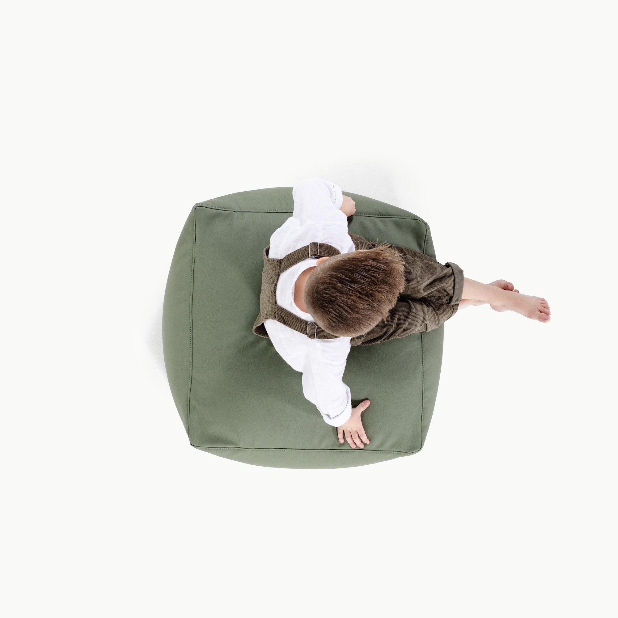 Thyme@Overhead of kid sitting on a Thyme Square Pouf