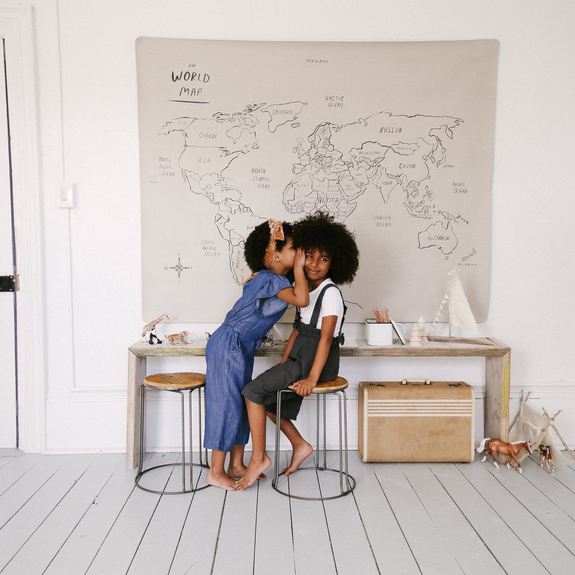 World Map@Midi+ World Map hanging on wall behind to little kids