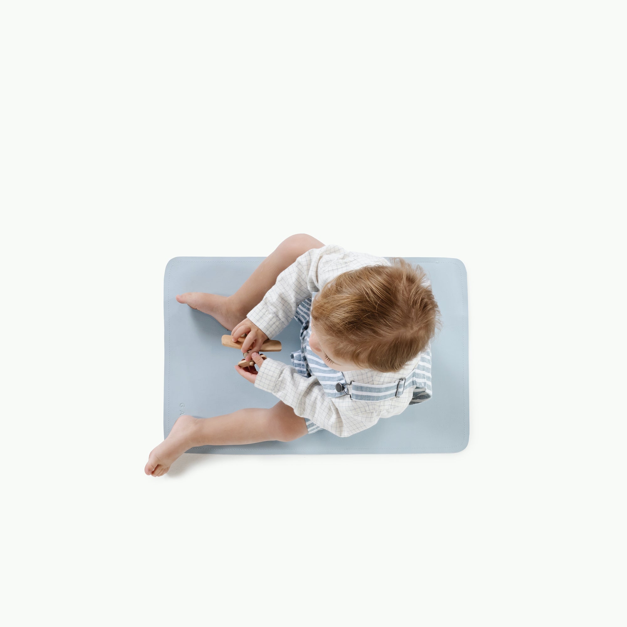 Beau@Overhead image of boy sitting on Beau Changing Mat