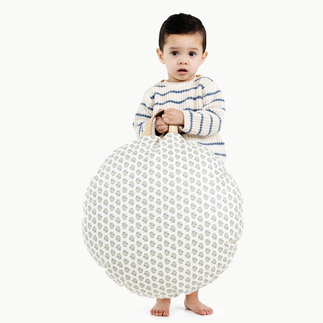 Meadow / Circle@kid holding up the meadow circle mini circle floor cushion