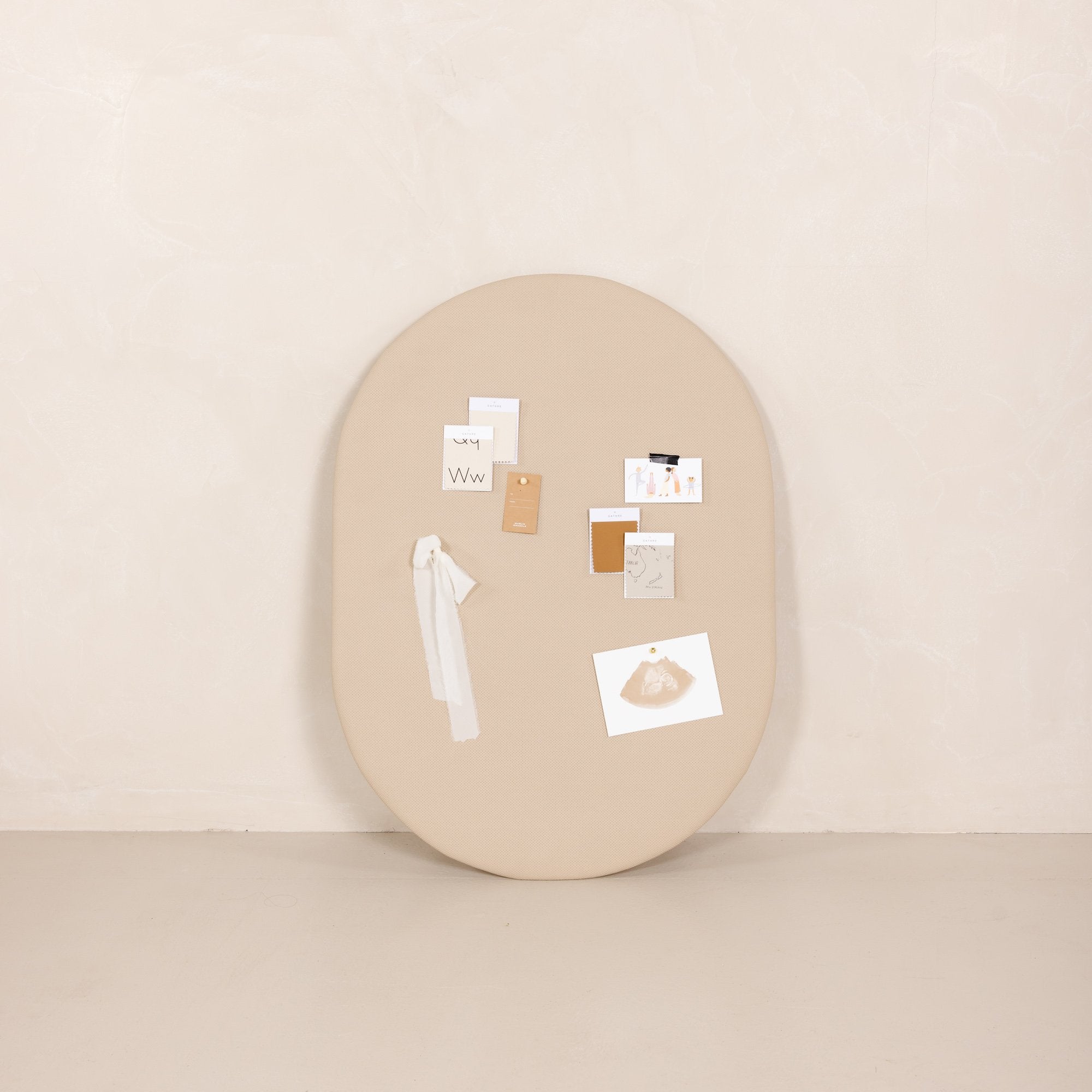 Millet@Millet Pinboard with object pinned on, leaning against wall