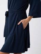Navy@woman wearing a navy cozy earth robe