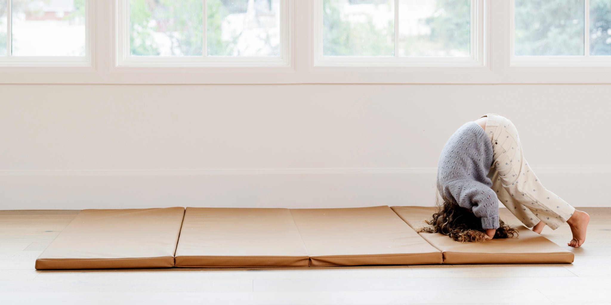 Kid playing on the Gathre Tumbling Mat in a home