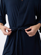 Navy@woman wearing a navy cozy earth robe