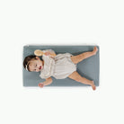 Amalfi@overhead of little girl laying on padded mat