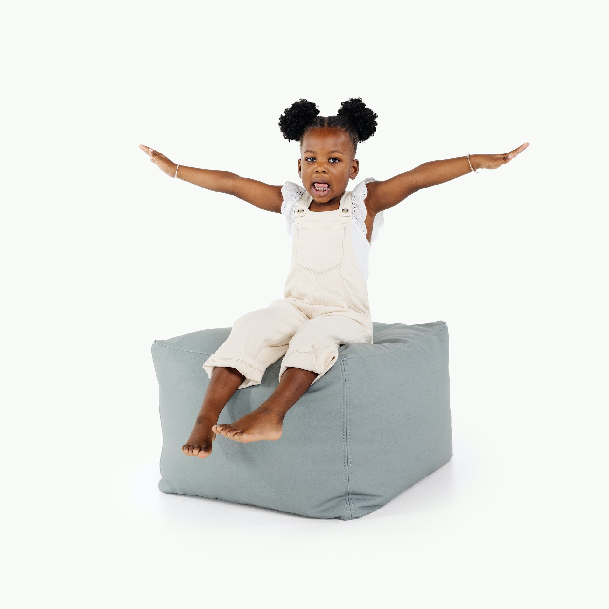 Amalfi (on sale)@little girl sitting on pouf