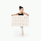 Ballet Basics@kid holding the ballet basics micro mat