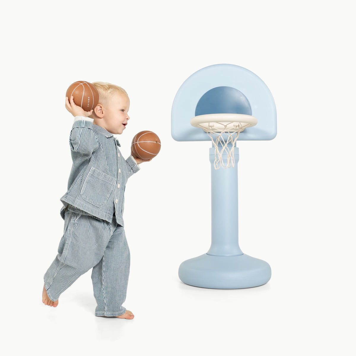 Quarry@Toddler using a basketball hoop to practice coordination and movement