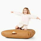 Camel / Square@little girl sitting on floor cushion