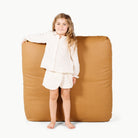 Camel / Square@little girl holding floor cushion