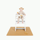 Camel / Mini@baby in a highchair on the mini camel mat