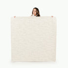 Cantata (on sale) / Square@woman holding up the sienna midi circle mat