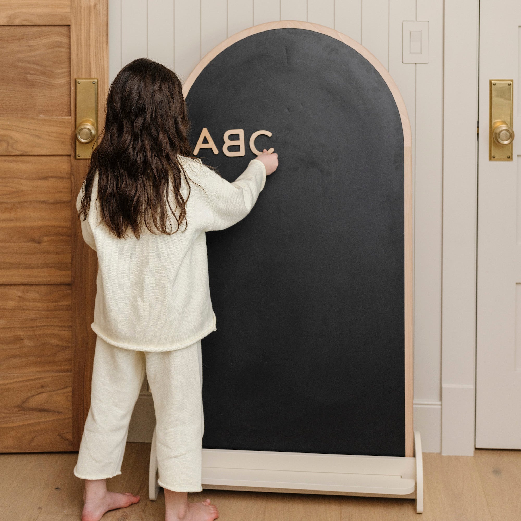 @Kid playing with the Arched Chalkboard + Wooden Numbers.