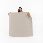 Fog • Camel (on sale)@woman holding up the Fog • Camel Midi Square Mat