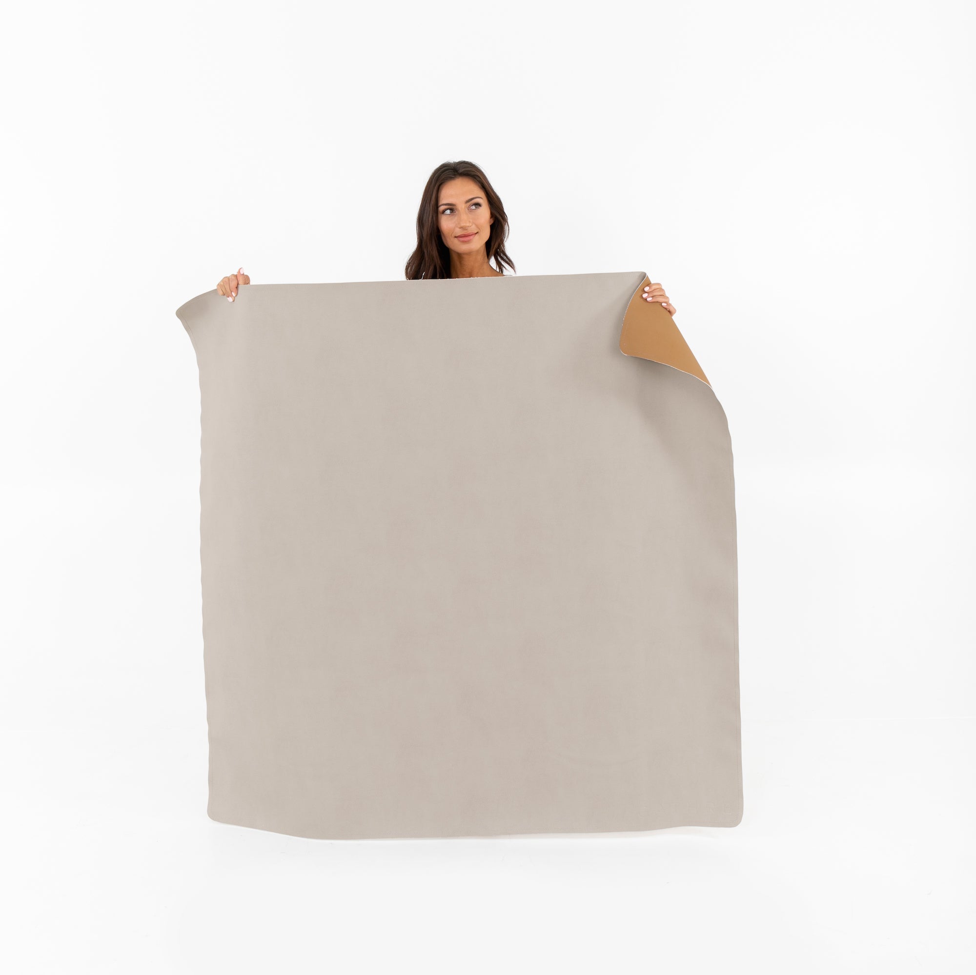 Fog • Camel (on sale)@woman holding up the Fog • Camel Midi Square Mat