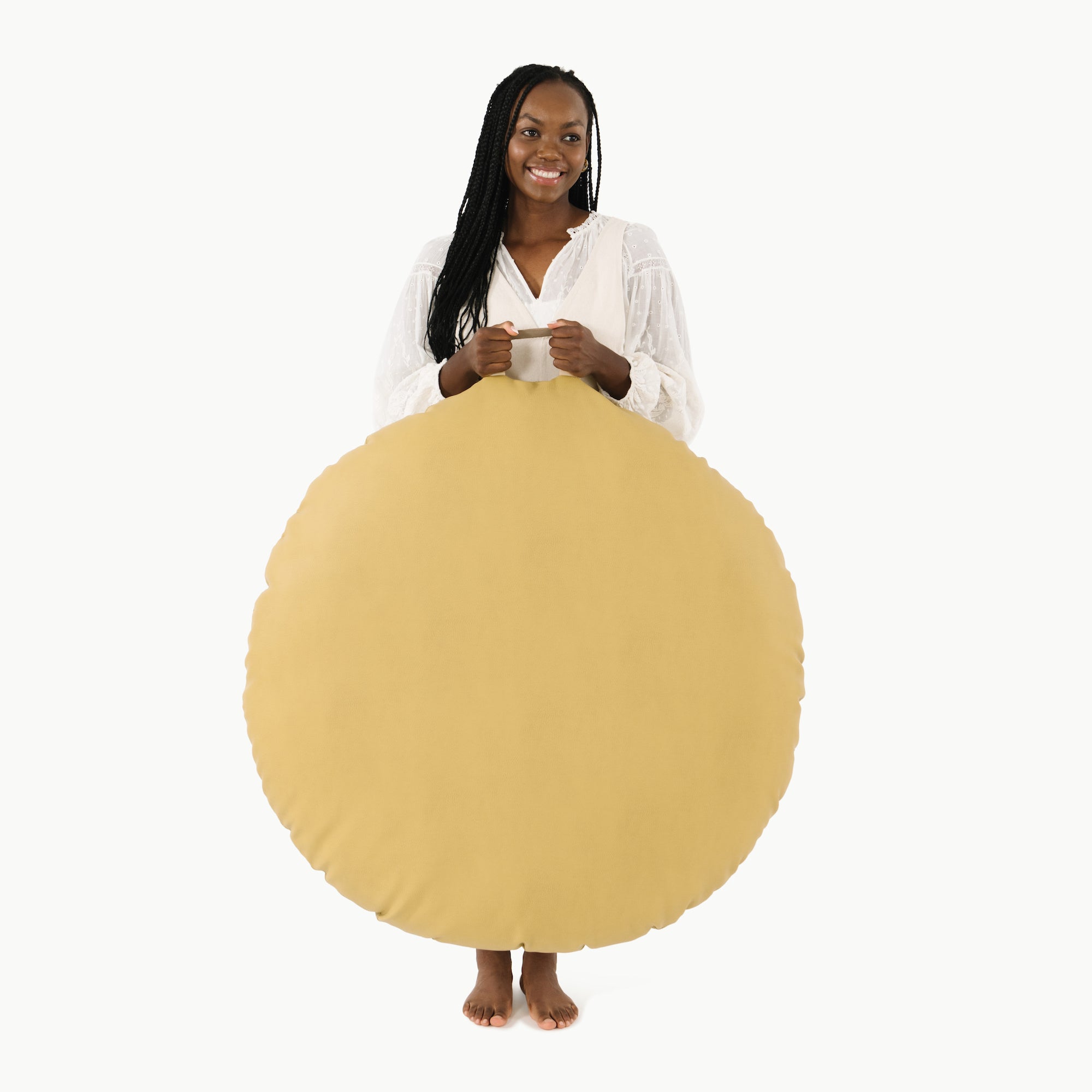 Soleil (on sale) / Circle@woman holding up the soleil circle floor cushion