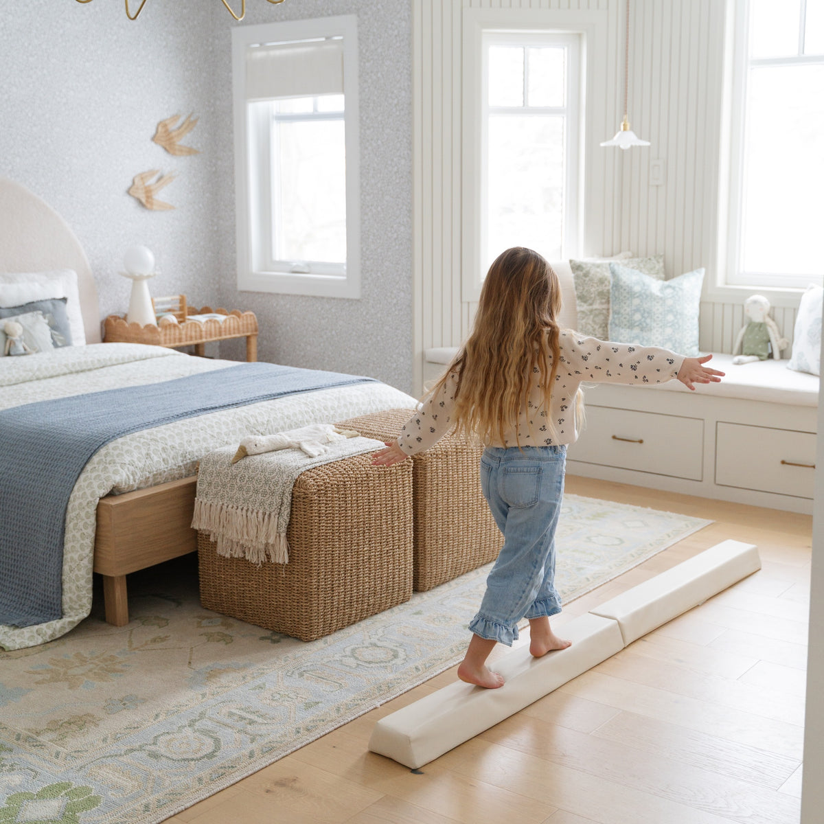 Ivory@lifestyle image of little girl playing on balance beam