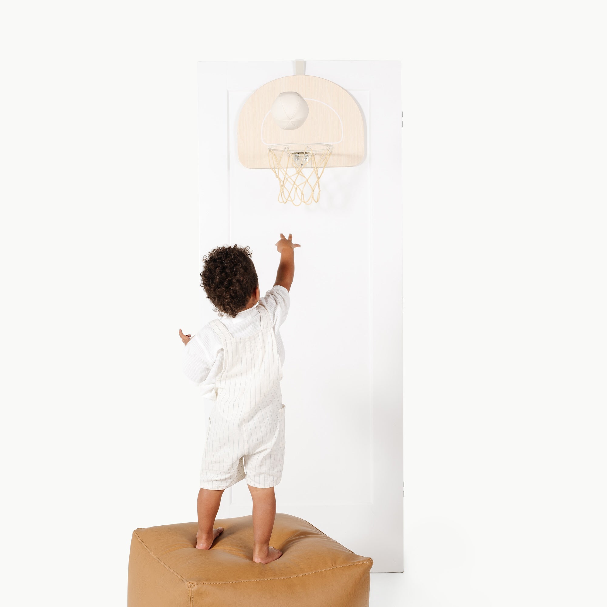 Ivory@Child using an over-the-door basketball hoop for indoor practice
