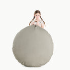 Fern (on sale) / Circle@Kid holding the Fern Circle Floor Cushion