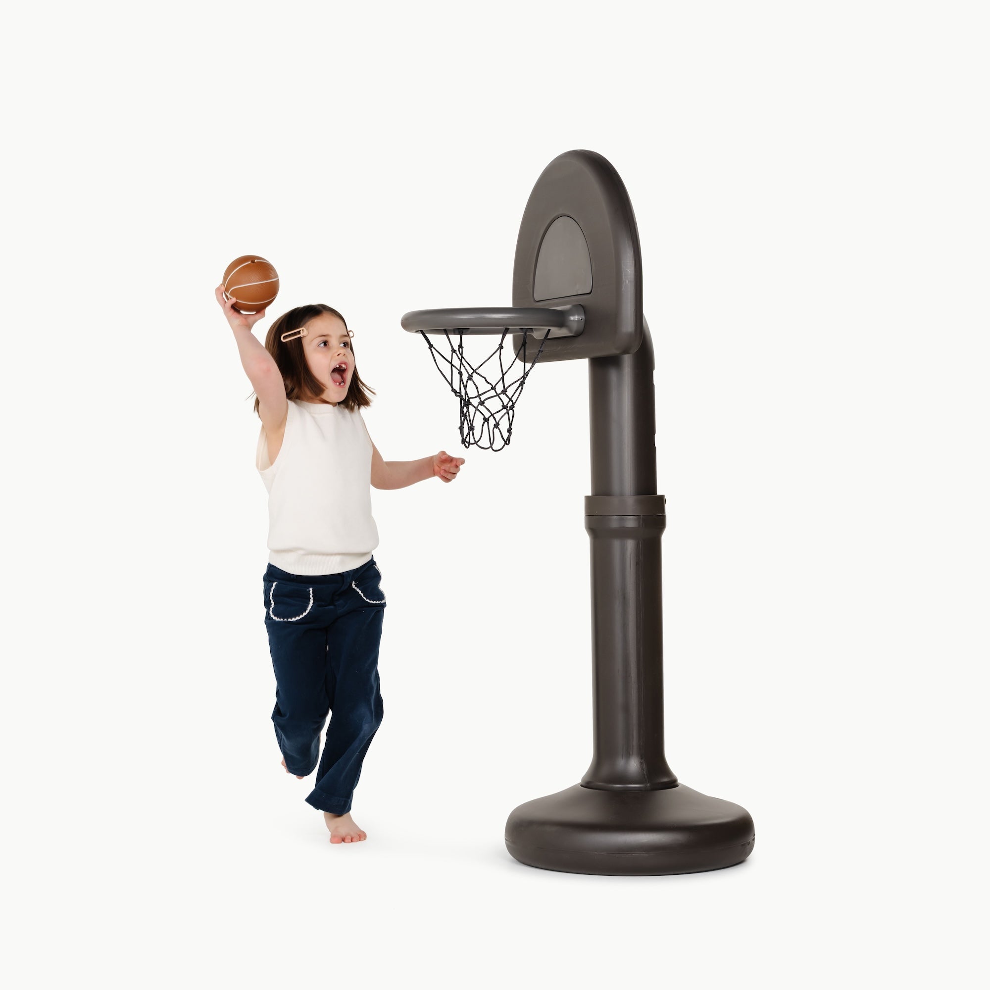 Raven@Toddler using a basketball hoop to practice coordination and movement