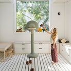 Palm@kid playing with the palm basketball hoop in a home