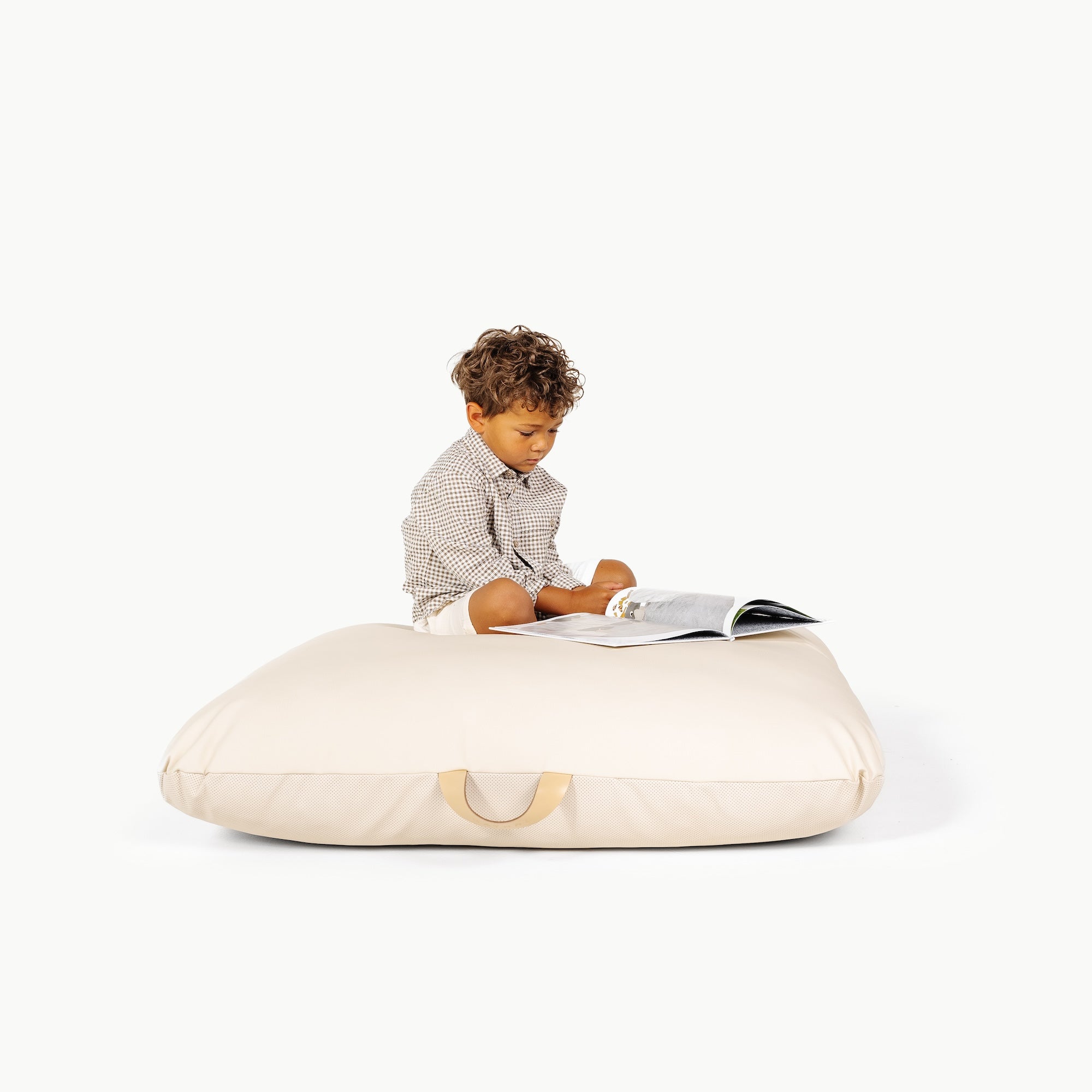 Ivory / Square@little boy sitting on the Ivory Floor Cushion