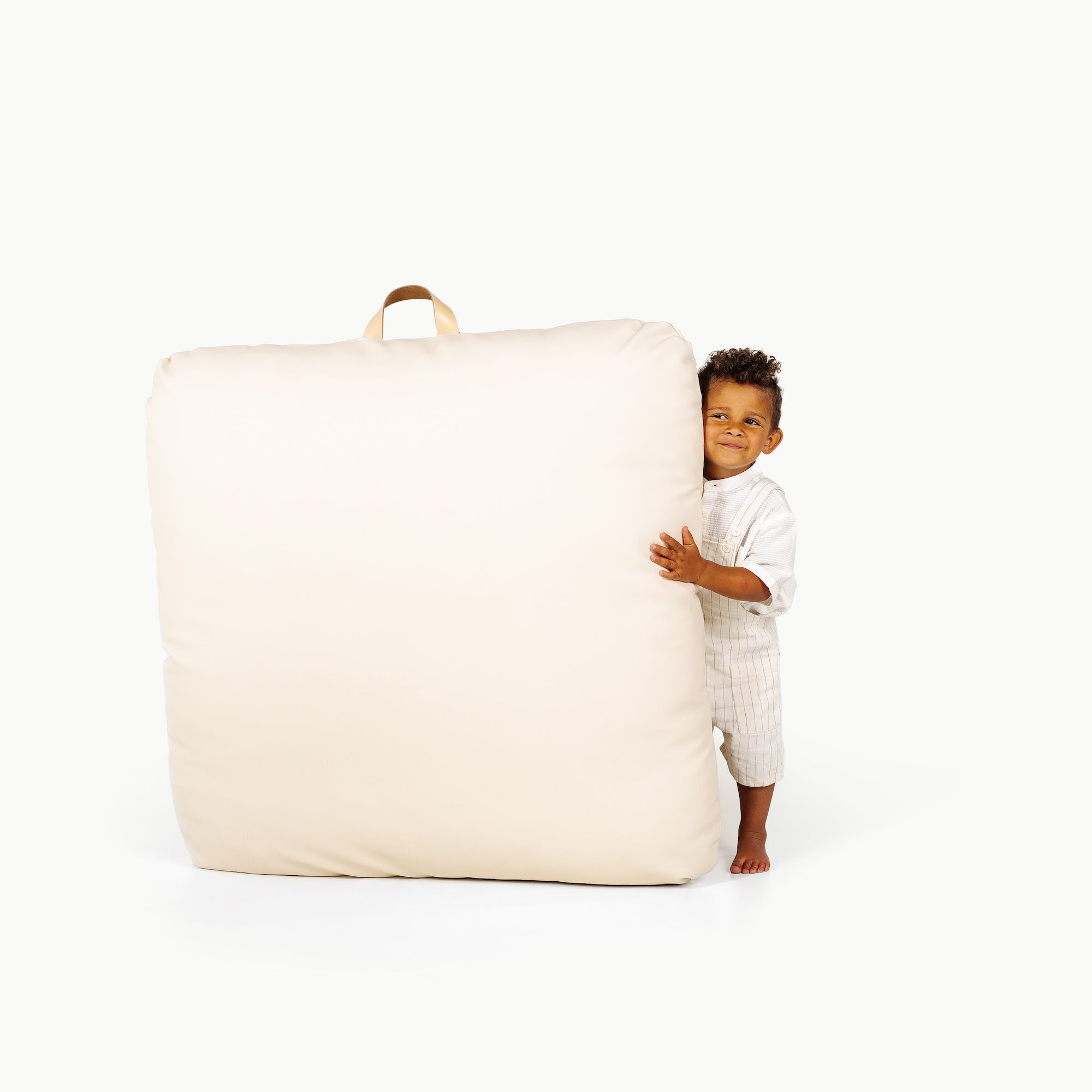 Ivory / Square@little boy holding the Ivory Floor Cushion