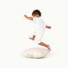 Ivory / Square@Little boy playing on the Ivory Mini Square Floor Cushion