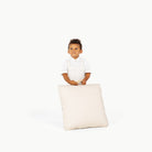 Ivory / Square@Little boy holding the Ivory Mini Square Floor Cushion