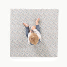 Joanna Bloom / Square@overhead image of little boy sitting on padded mini