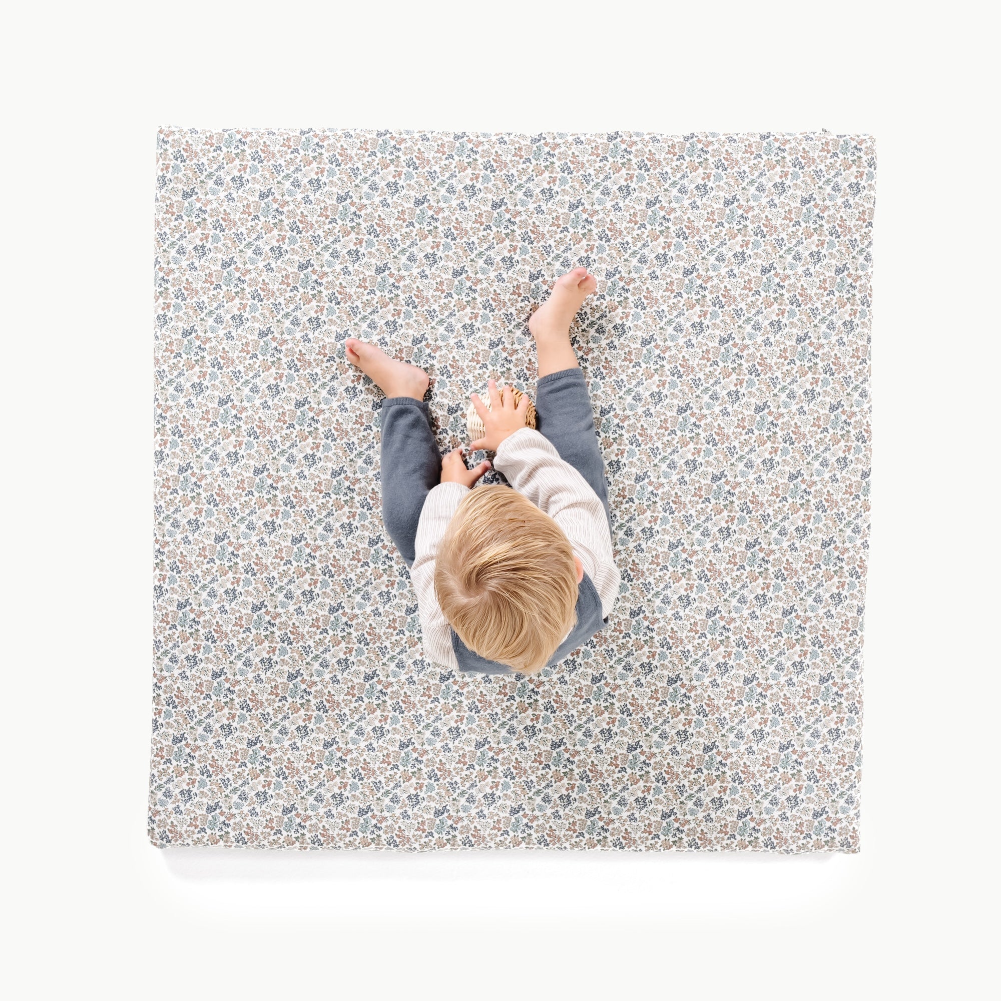 Joanna Bloom / Square@overhead image of little boy sitting on padded mini